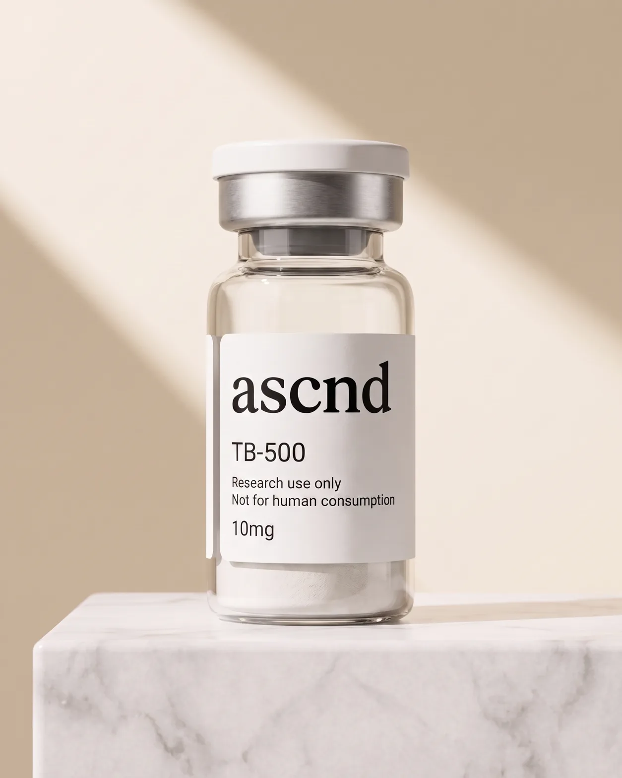 Clear glass ASCND vial with a white research-use-only label, on a stone ledge